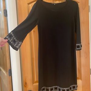 Beautiful sleeve and hem Embellishments! Perfect little black dress!